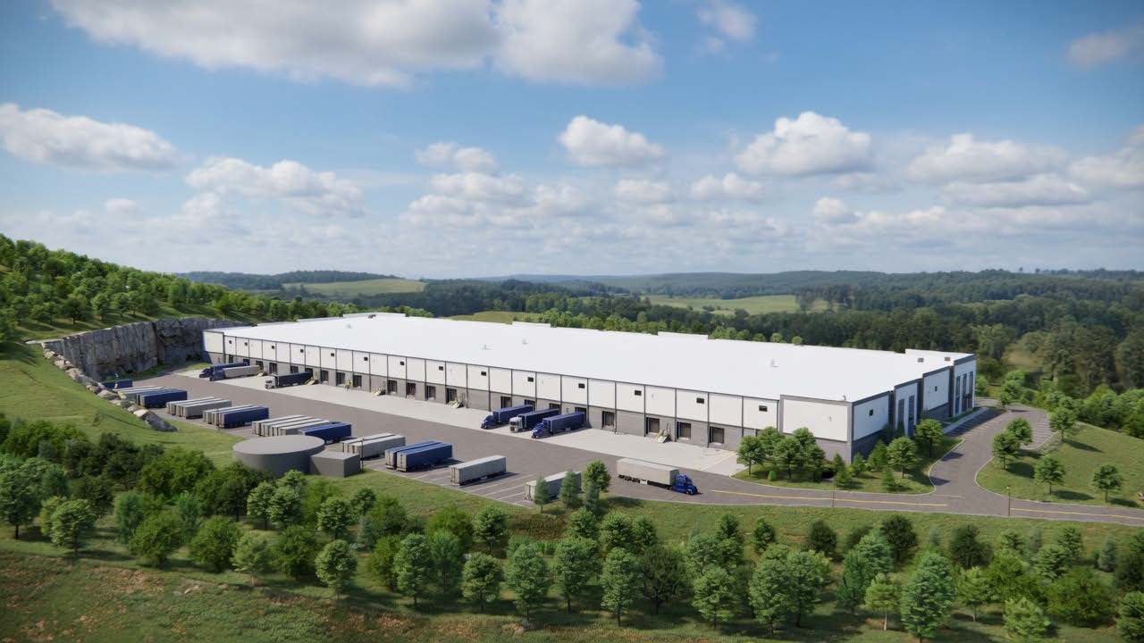 Aerial rendering of the building with loading dock doors and trailer storage